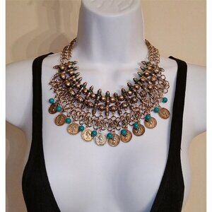 Brassy antique gold tone chain mesh statement coin bib necklace.